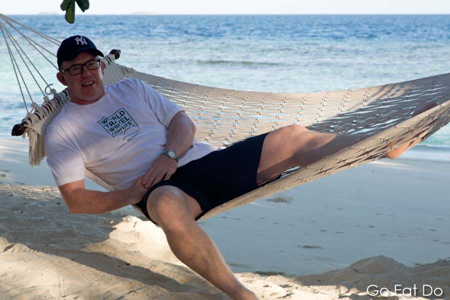 Travel writer and blogger Stuart Forster on a hammock by the Indian Ocean during the World Travel Writers Conference at the Bandos Maldives Resort in the Maldives