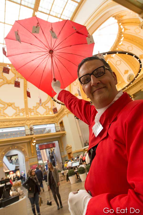 Jean Til with his red, heart-shaped umbrella in the Stadsfeestzaal shopping centre in Antwerp, Belgium.