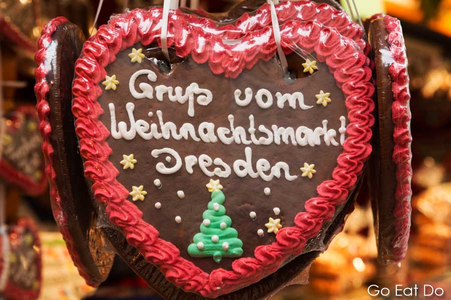 'Greetings from Dresden Christmas Market' says icing sugar writing on the gingerbread heart Striezelmarkt in Germany