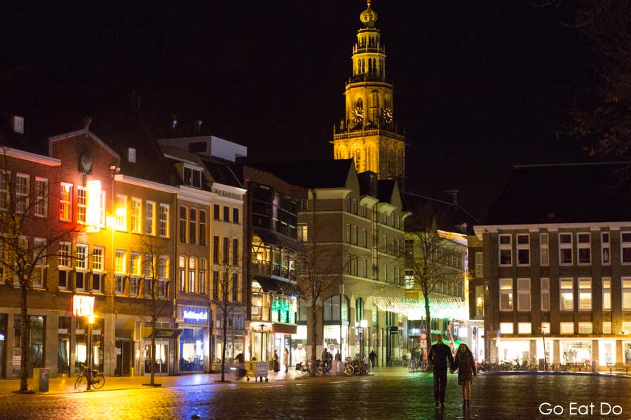 Tower of the Martinikerk towering above the Vismarkt at night in central Groningen, the Netherlands