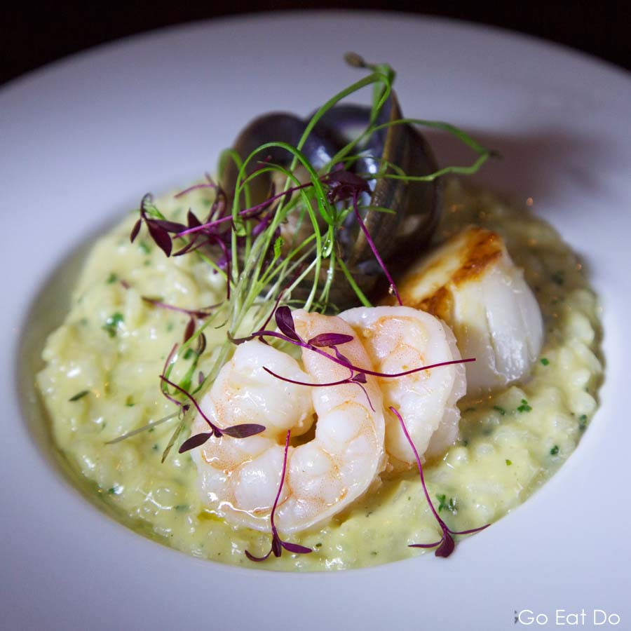 Seafood risotto layered with prawns, a scallop and clams served as a starter at The Rib Room restaurant at Ramside Hall in Durham, England