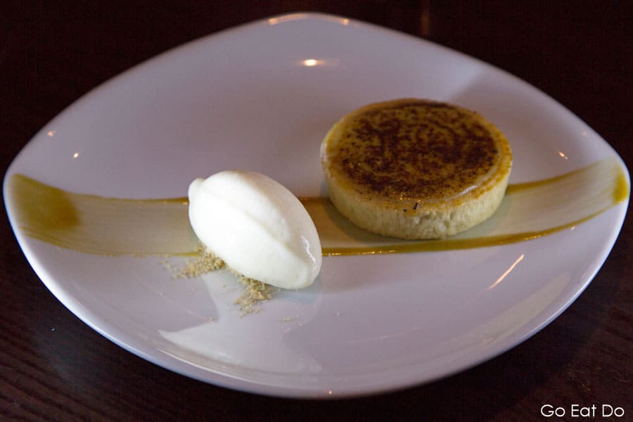 Salted caramel tart served with ice cream served as dessert at The Rib Room restaurant at Ramside Hall in Durham, England