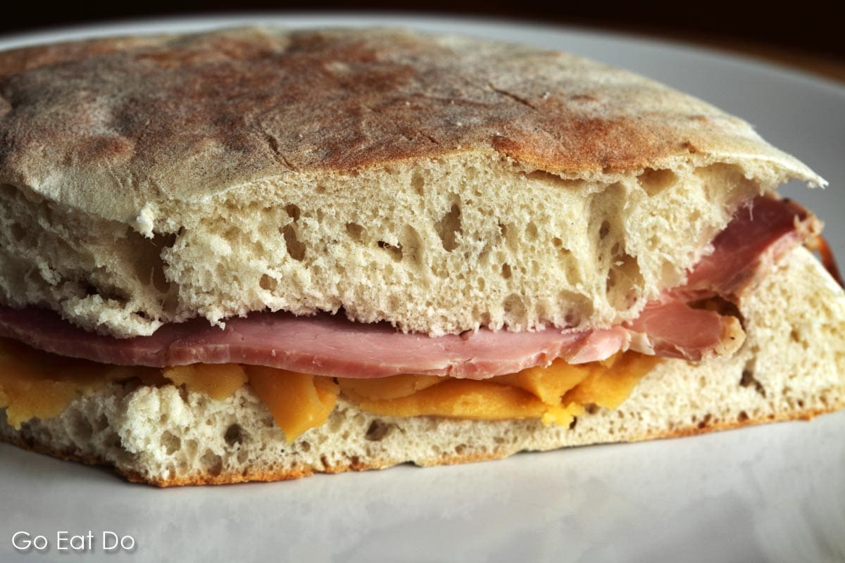 Ham and pease pudding sandwich made from stottie cake, a traditional bread from North East England.