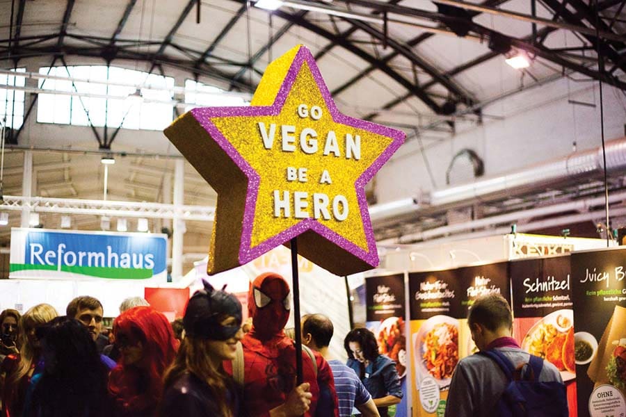 Star-shaped sign saying 'Go Vegan be a Hero' at Veggie World