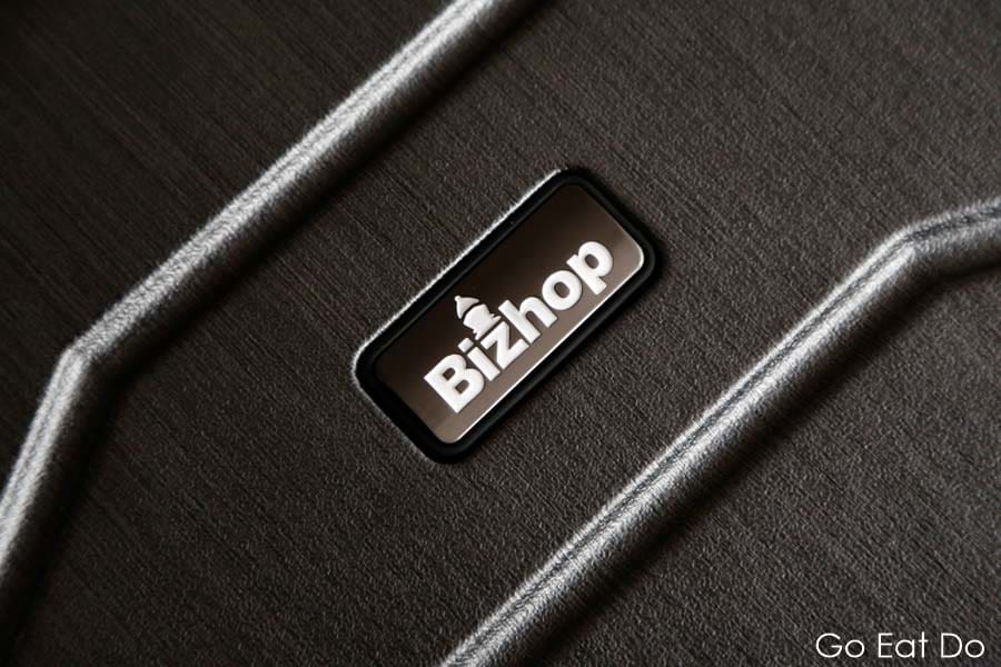 Bizhop logo on the exterior of a suitcase designed as business luggage