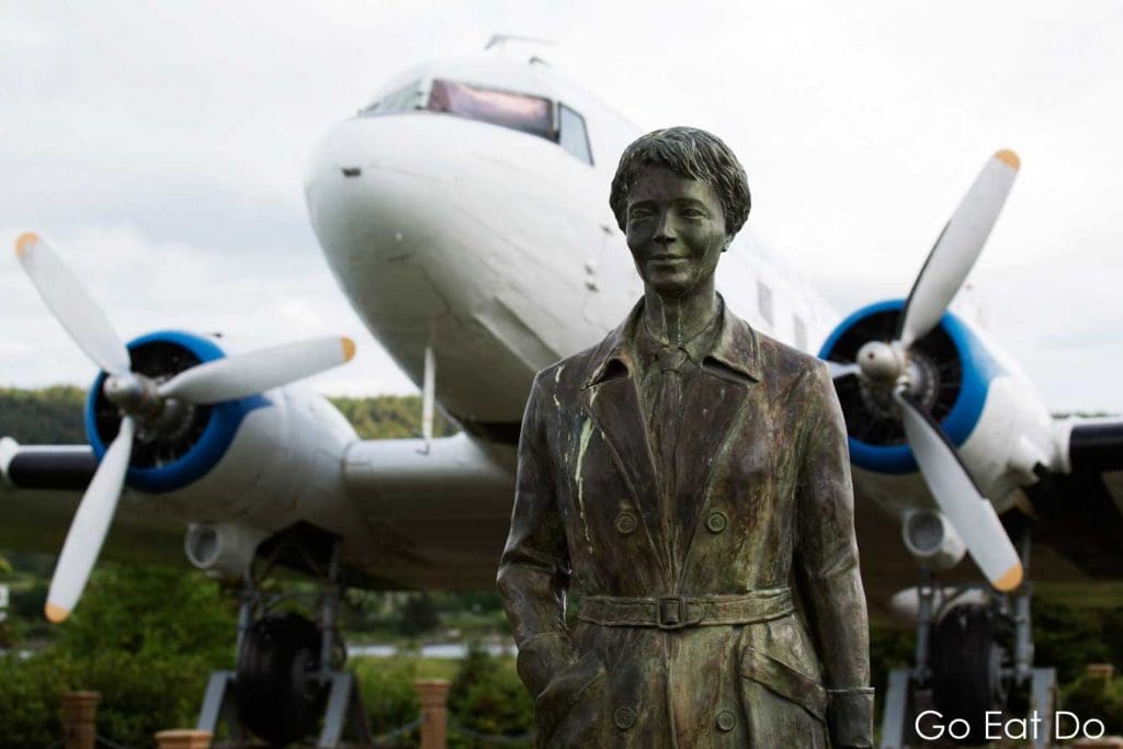 Memorial to female aviator Amelia Earhart Putnam , in front of an aircraft, at Harbour Grace, Newfoundland and Labrador, Canada