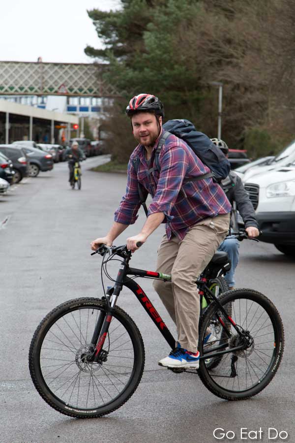 Bearded male cyclist riding an electric bicycle hired from Cyclexperience at Brockenhurst in the New Forest National Park, England