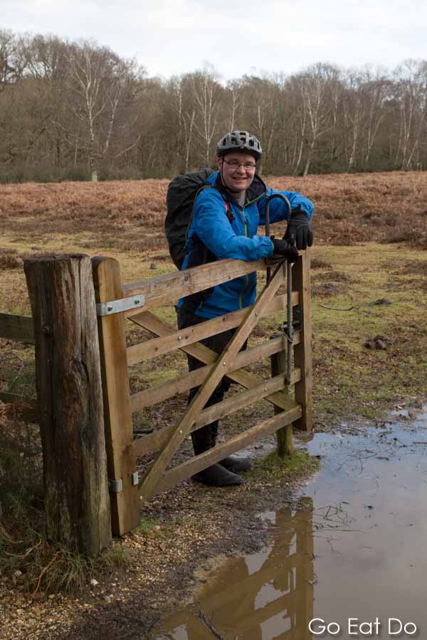 John Thurnell-Read holds open a gate on one of the trails in the New Forest.