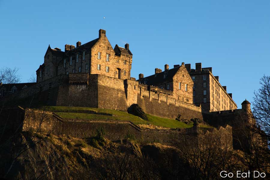 Edinburgh Castle on Castle Rock on a sunny, blue sky day in Edinburgh, Scotland
