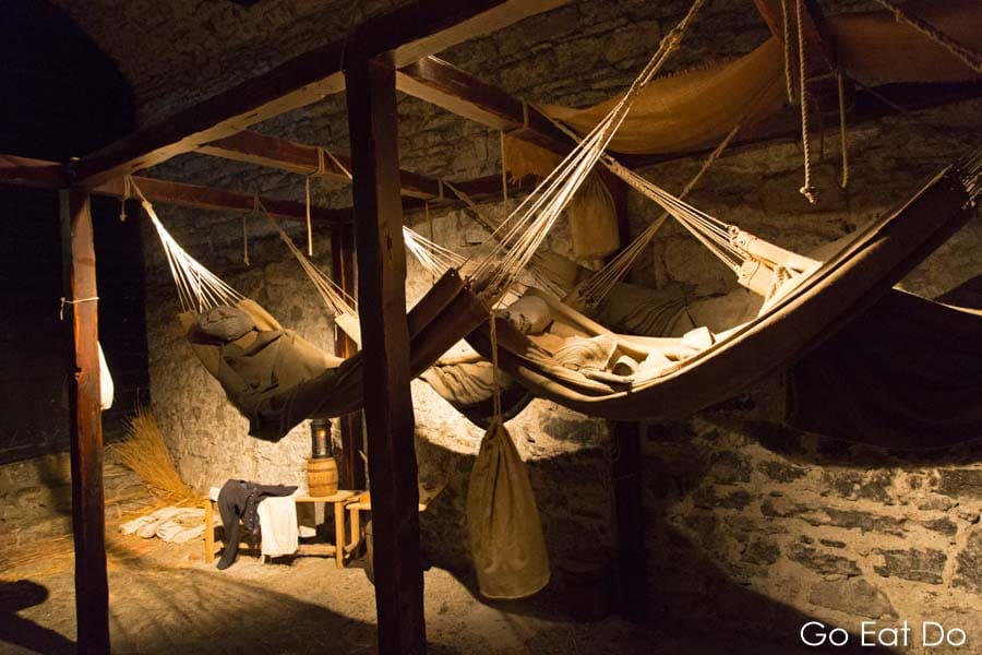 Hammocks hang in the recreation of prison cells in which French prisoners were held in the 1790s and early 1800s at Edinburgh Castle