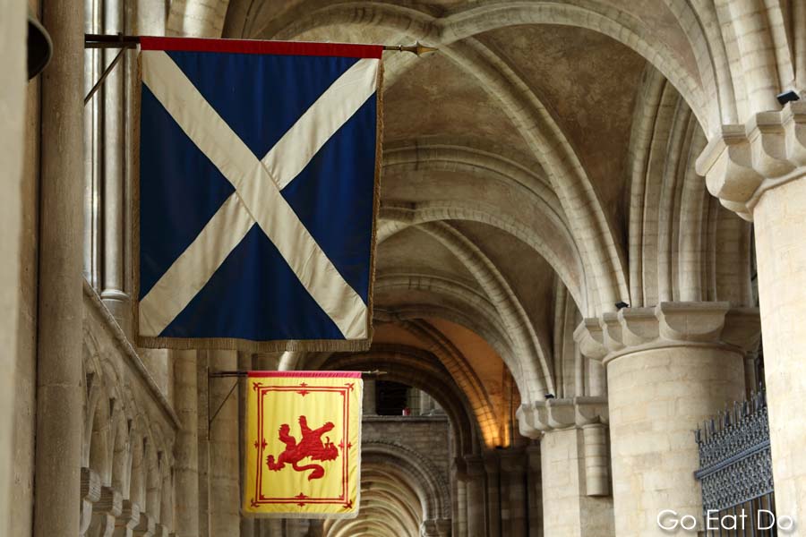 Scottish St Andrews and Saltire flags mark the original grave of Mary Queen of Scots at Peterborough Cathedral in England