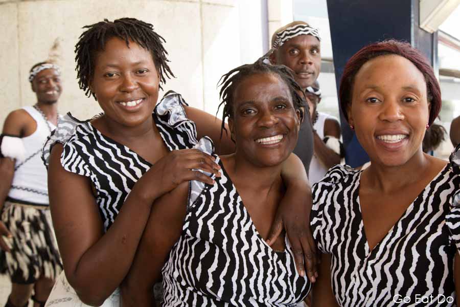 Smiling members of a Zimbabwean dance group after welcoming arrivals to Robert Gabriel Mugabe International Airport in Harare, Zimbabwe