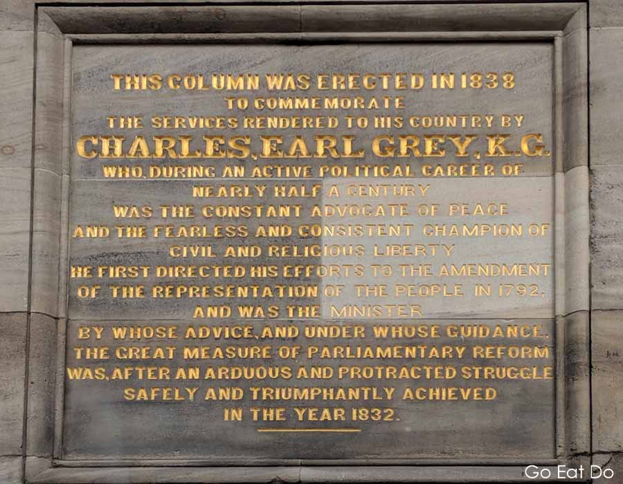 Inscription on Grey's Monument in Newcastle, explaining why the column was erected in 1838 to commemorate the achievements of Charles, Earl Grey, the British Prime Minister from 1830 to 1834.