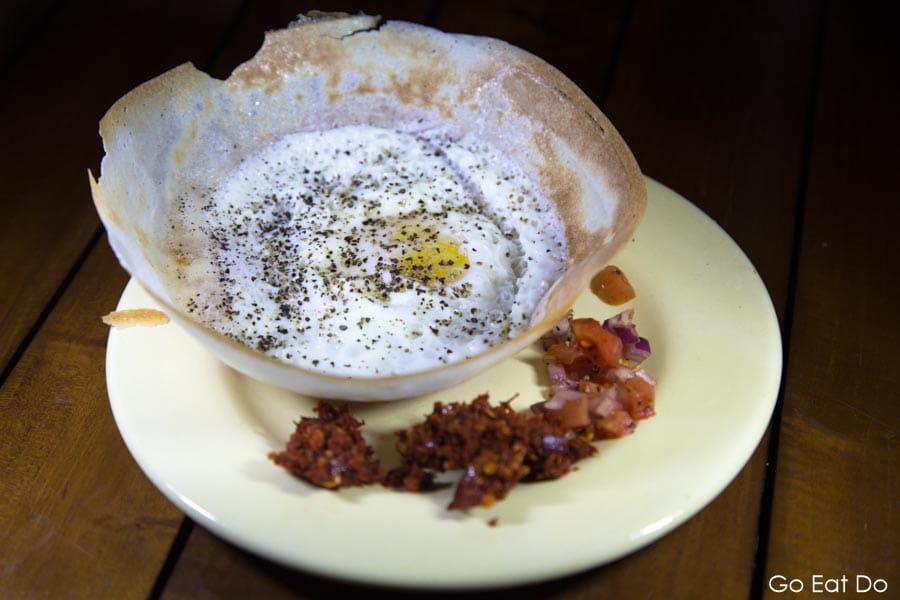 Egg hopper served with chutney at Nuga Gama, a Sri Lankan village style restaurant at the Cinnamon Grand Hotel in Colombo, Sri Lanka