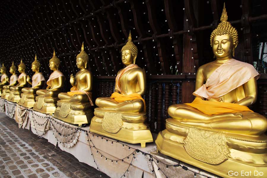 Golden Buddha statues at Seema Malaka Temple, designed by Geoffrey Baw, a Buddhist temple in Colombo, Sri Lanka