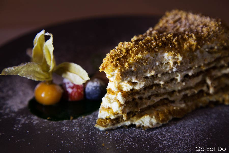 Slice of Honey Cake, a Latvian delicacy, served with fruit in Riga, Latvia