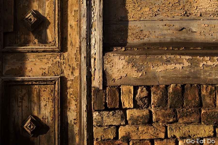 Peeling paint on old, wooden architecture of a house in central Riga, Latvia