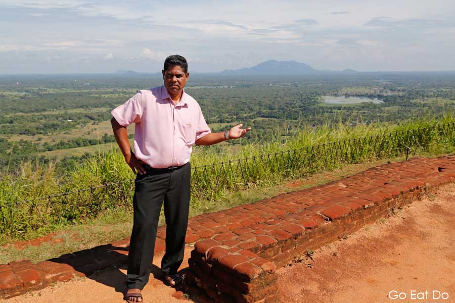 Luxman Perera, chauffeur-guide talking about the landscape visible from Sigiriya UNESCO World Heritage Site near Dembulla in Sri Lanka