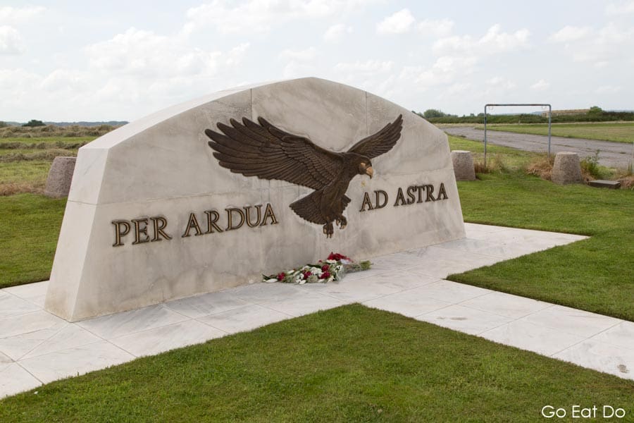 Eagle and the Latin inscription Ped Ardua Ad Astra on the flying services memorial at the Saint-Omer - Wizernes Aerodrome at Longuenesse, near St Omer, France