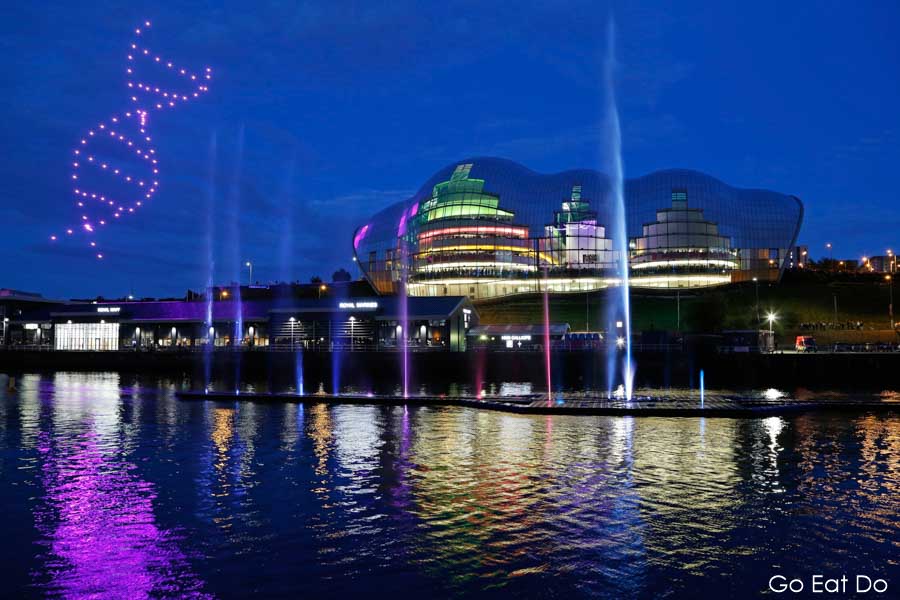 Drones display DNA double helix in the blue hour by the Sage Gateshead at Great Exhibition of the North opening ceremony in NewcastleGateshead