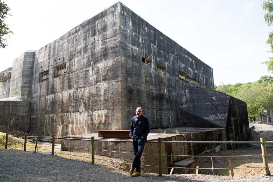 Stuart by the concrete bunker of the Eperlecques Blockhaus, which was designed to construct and launch V2 rockets.