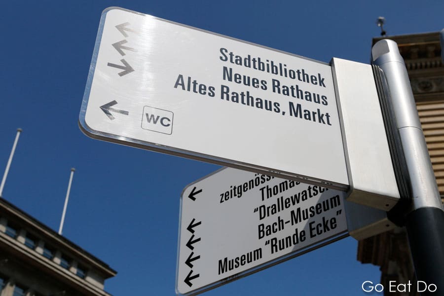 Sign pointing visitors to tourism attractions and landmarks in central Leipzig