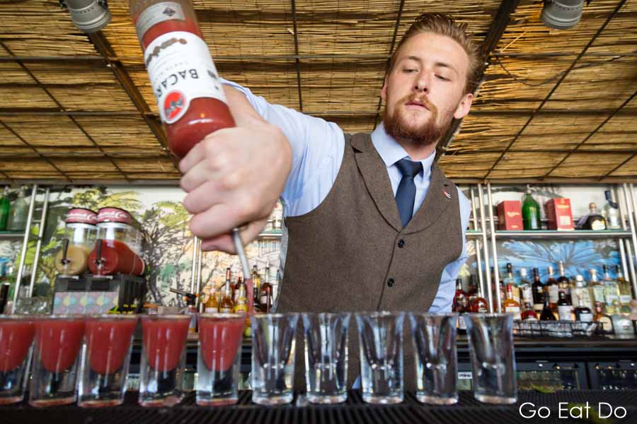 Barman Barney pouring shots at Revolucion de Cuba in Newcastle