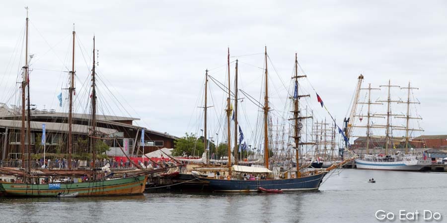 Sailing ships moored on the River Wear, in front on the National Glass Centre, during the 2018 Tall Ships Race in Sunderland, England