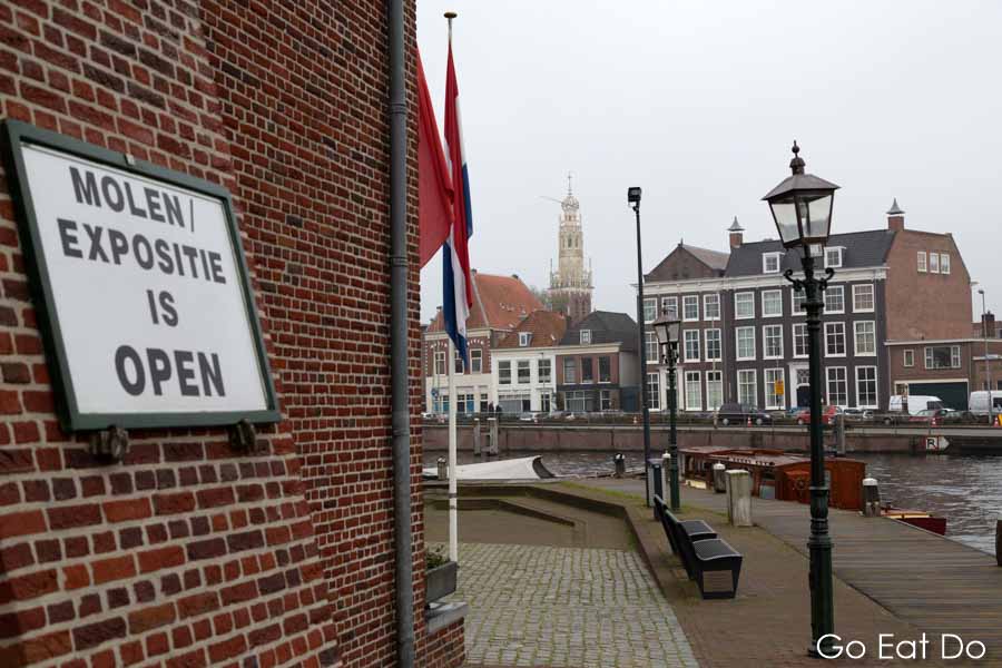 A sign informs visitors that the exhibition is open at the De Adriaan windmill (Molen de Adriaan) in Haarlem.