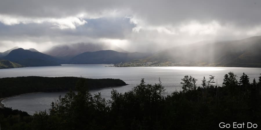 Sunbeams burst through clouds over Bonne Bay in western Newfoundland, Canada
