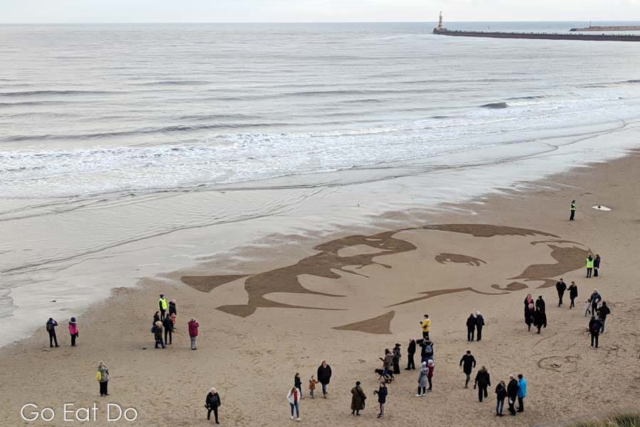 Portrait of Second Lieutenant Hugh Carr on Roker Beach as part of Danny Boyle's Pages of the Sea in Sunderland. The North Sea laps onto the beach.