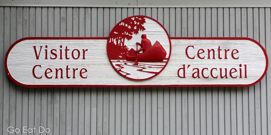 Sign for the Visitor Centre, or the Centre d'accueil in French, at Kejimkujik National Park and National Historic Site in Nova Scotia, Canada