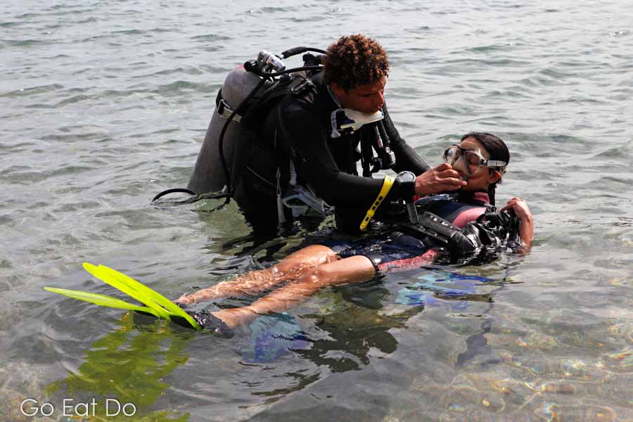 PADI diving instructor with a beginner learning to dive in Red Sea waters off Sharm el Sheikh, Egypt