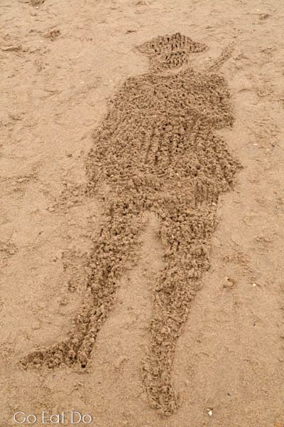 Shape of a British World War One soldier raked into sand on Roker Beach as part of Danny Boyle's Pages of the Sea in Sunderland,