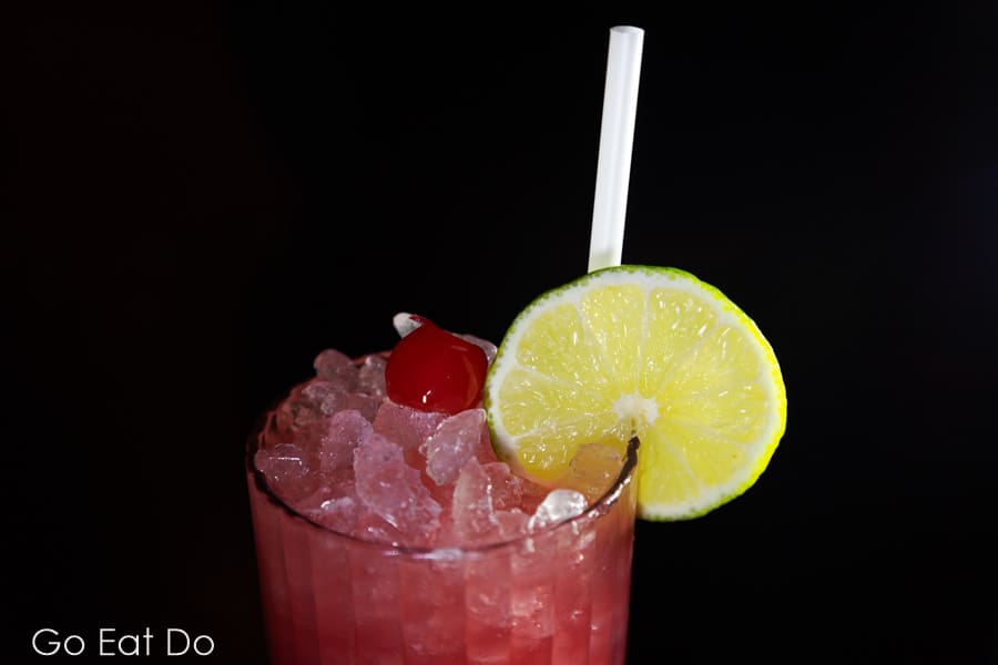 Cherry pop soda served with a wedge of lemon and a paper straw at Pizza Punks in Newcastle upon Tyne