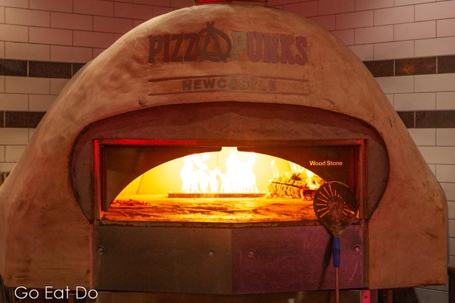 The wood-fired pizza oven in the open kitchen at Pizza Punks Newcastle.