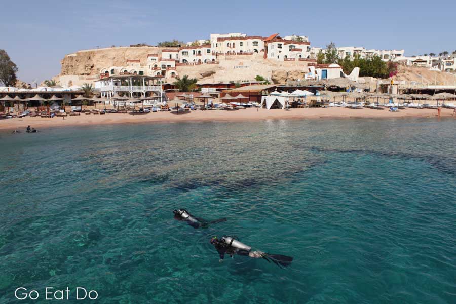 Scuba divers enjoying the clear Red Sea water at Sharks Bay at Sharm el Sheikh, Egypt