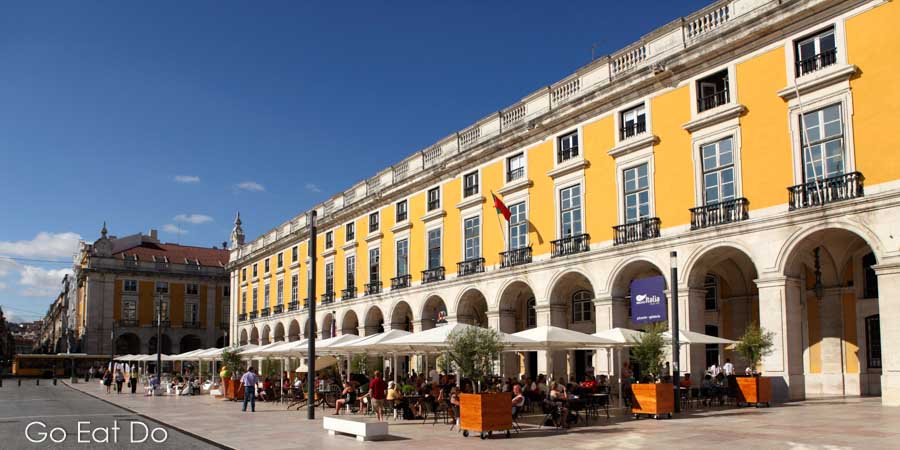 Tables and chairs of cafes and restaurants at the the Terreiro do Paco, which is also known as the Praca do Comercio.