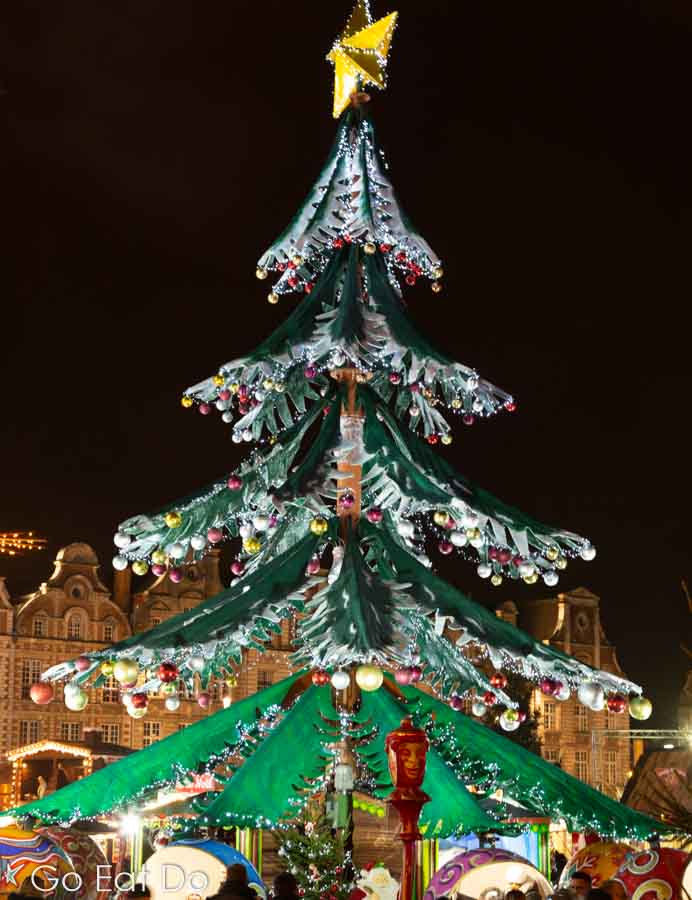 Illuminated Christmas tree at night at Arras Christmas market in France