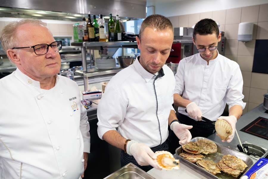 Marc Meurin and his team preparing scallops in the kitchen of Le Meurin restaurant at the Château de Beaulieu hotel in Busnes, France