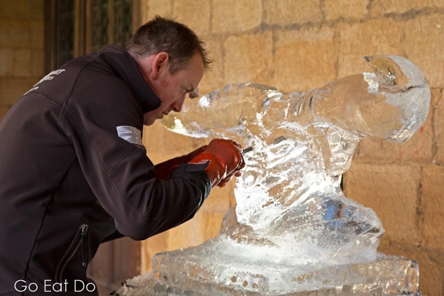 Matt Chaloner concentrating while sculpting a minotaur in the cloisters of Durham cathedral during Fire and Ice Durham