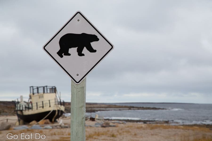 Sign warning people to be vigilant of polar bears by the coast in Churchill, Manitoba, Canada