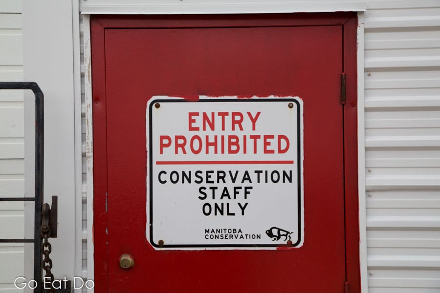 Sign on a door leading into the Polar Bear Holding Facility in Churchill, Canada, states entry prohibited and that conservation staff only are permitted to enter.