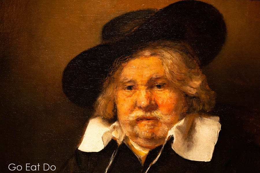 Detail of a self-portrait by Rembrandt van Rijn showing the artist as an old man wearing a tilted hat