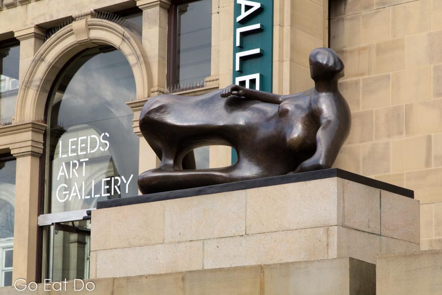 Henry Moore sculpture of a reclining woman outside the entrance of Leeds Art Gallery in Leeds, West Yorkshire