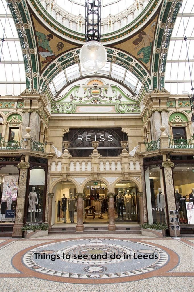 Pinterest pin showing the ornate Reiss facade at the County Arcade in the Victoria Quarter to illustrate the Go Eat Do blog post about a weekend break in Leeds