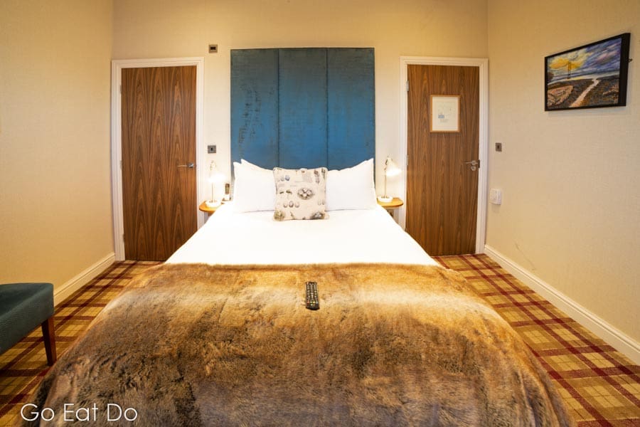 The bed and plush headboard in Pebbly Beach, a double bedroom at The Hope and Anchor South Ferriby gastropub in north Lincolnshire.