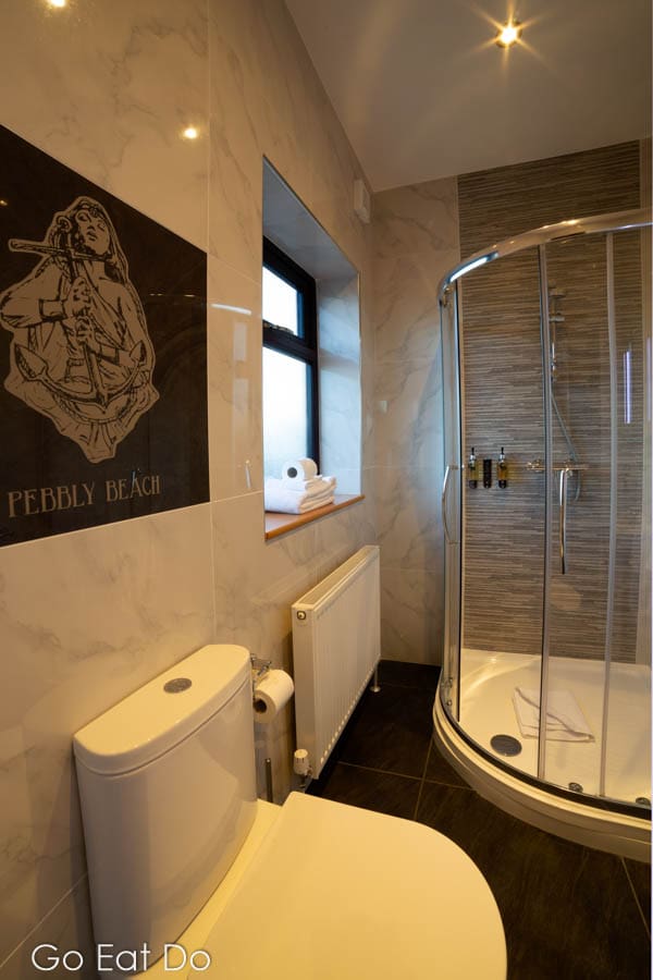 En-suite bathroom with a toilet, shower cubicle and window in the Pebbly Beach room at The Hope and Anchor pub in South Ferriby, Lincolnshine