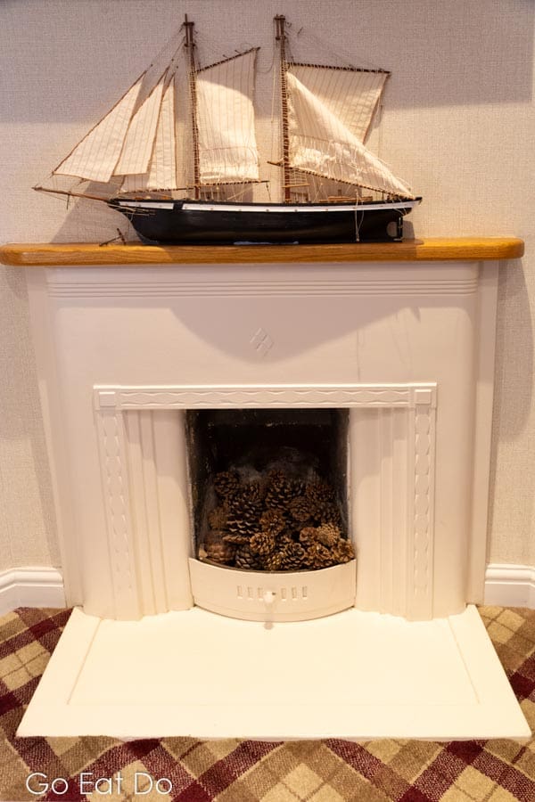 A model sailing ship above the fireplace in the Pebbly Beach guestroom at The Hope and Anchor in South Ferriby.
