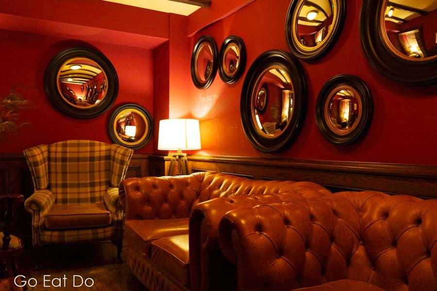 Leather seating and framed mirrors in the cosy snug of the Hope and Anchor South Ferriby pub.